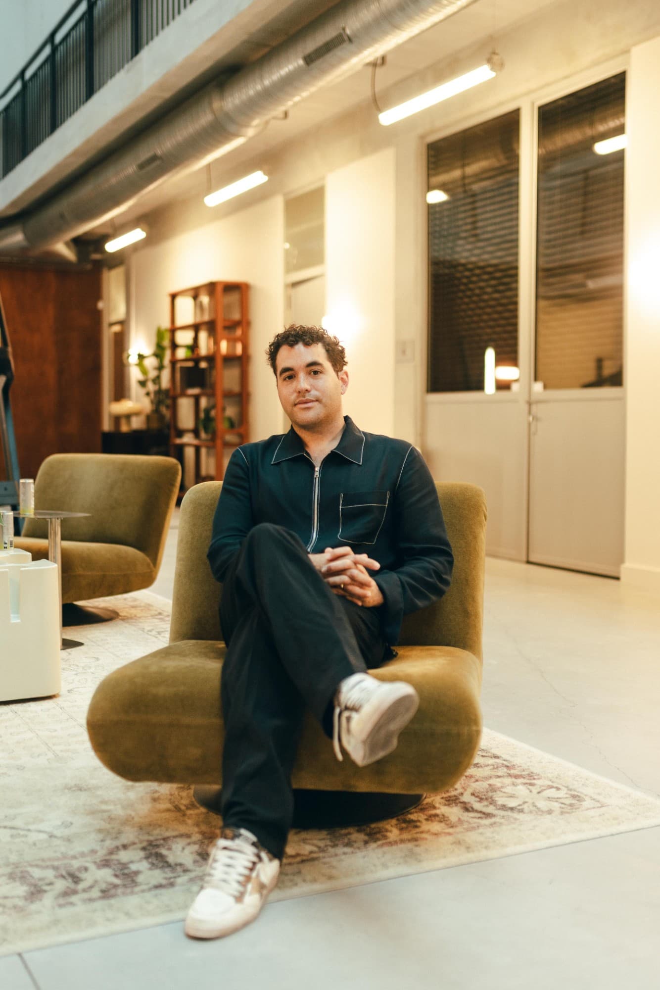 Marlon Maternati seated in an armchair at the office